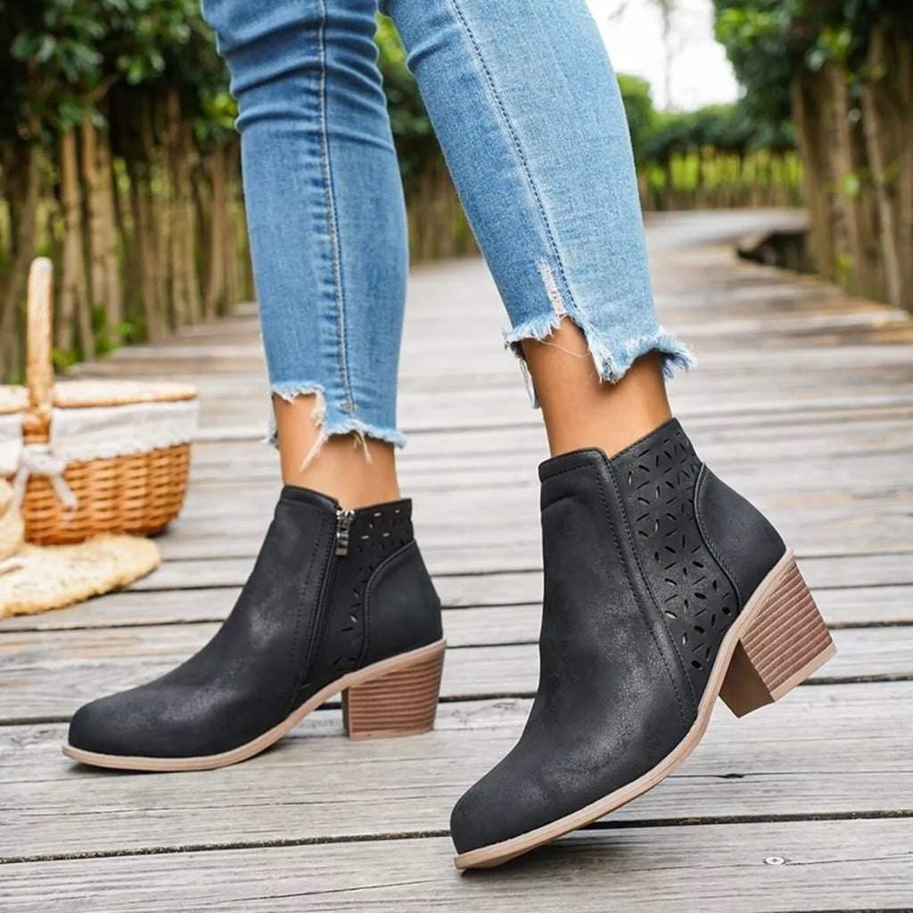Black ankle boots with block heel, cutout side detail, and easy pull-on panels