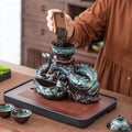 Ceramic dragon teapot set with rotating spout, teal glaze, dragon handles, tray and cups