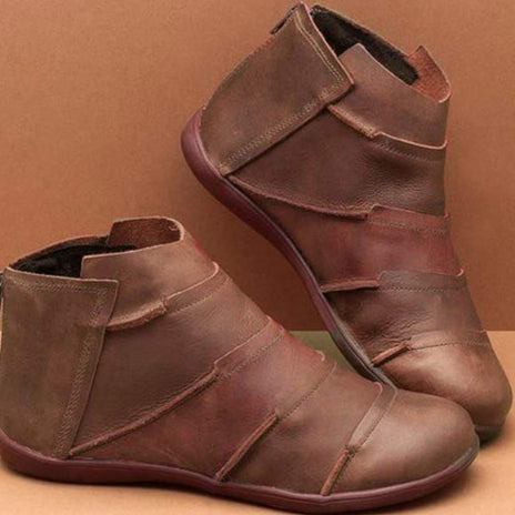 Brown short ankle boots with strap closure and side pull tab