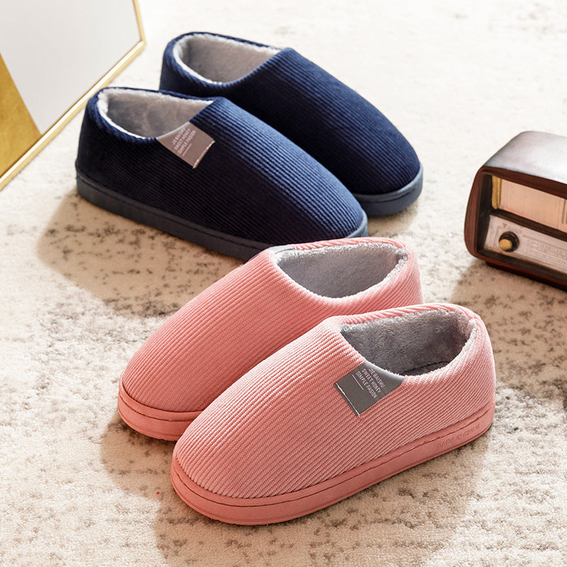 Navy and pink corduroy slip-on slippers, gray fuzzy lining, cushioned sole.