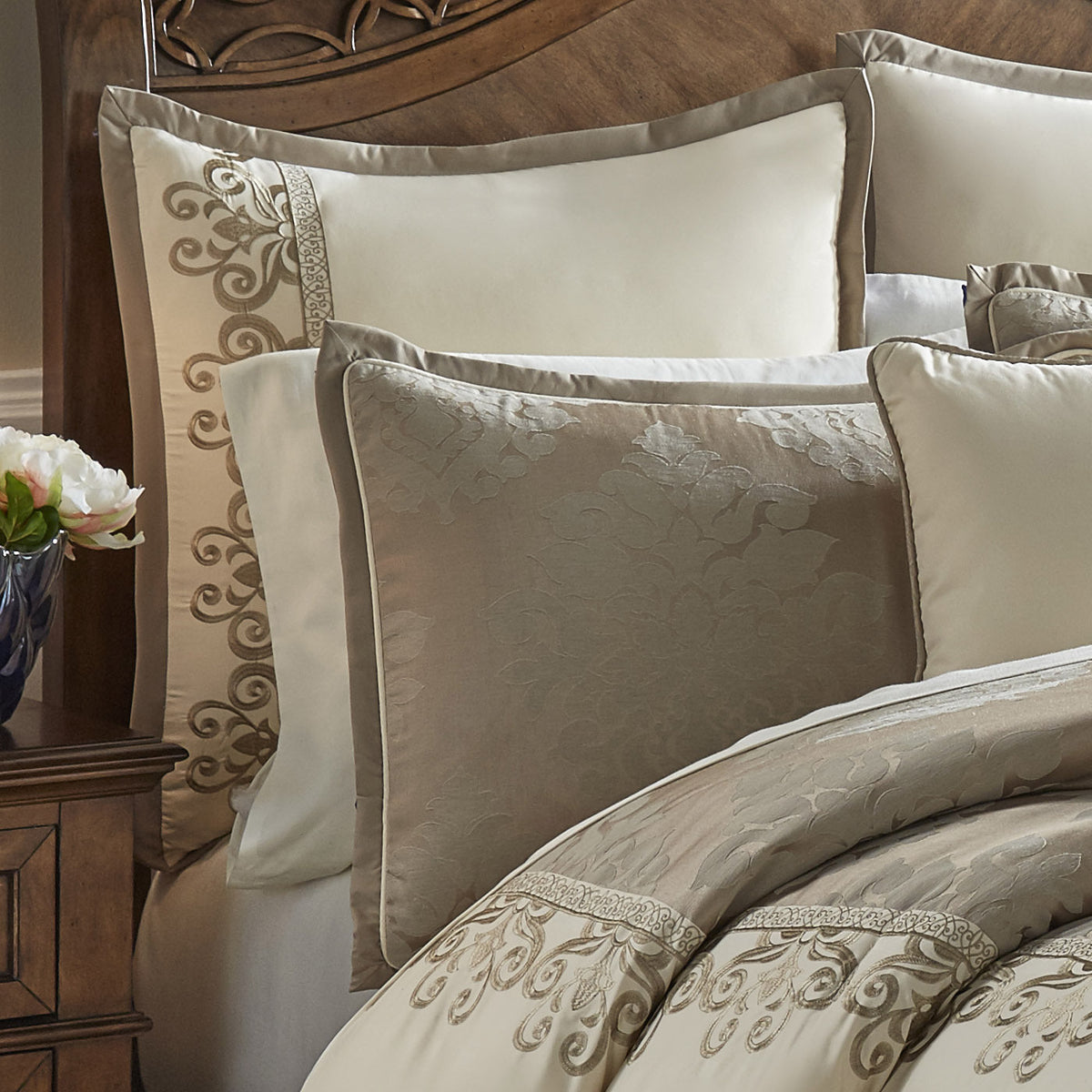 Ivory decorative pillows with embroidered scroll trim and jacquard comforter top