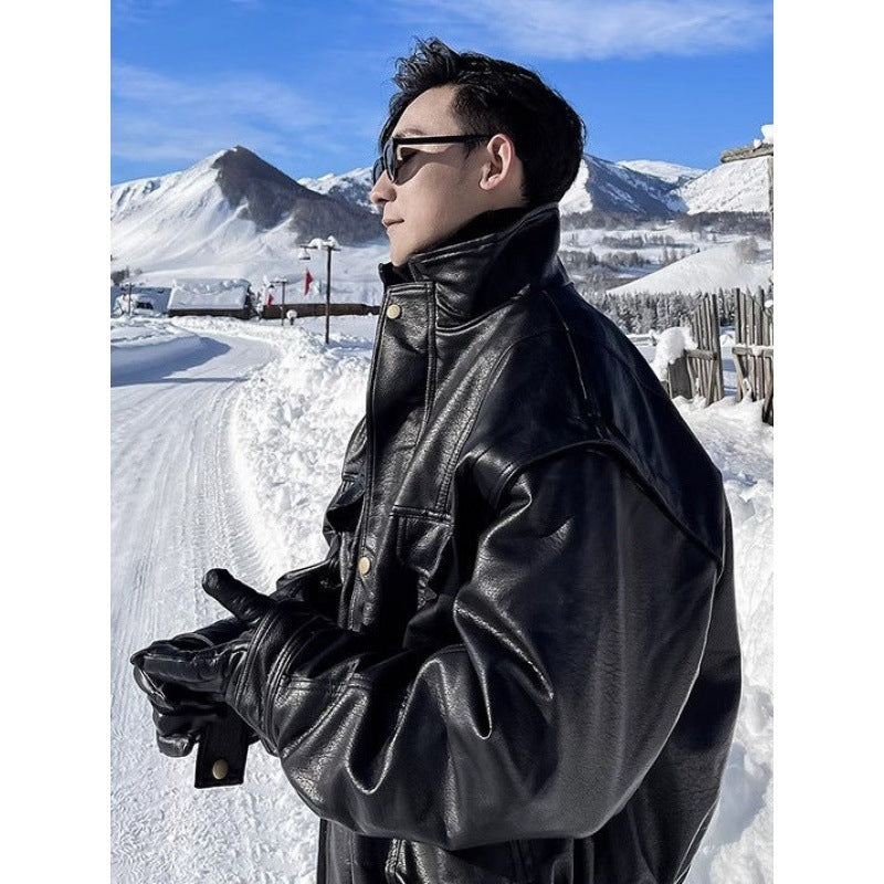 Men's black leather jacket with stand collar and snap chest pockets, angled side view