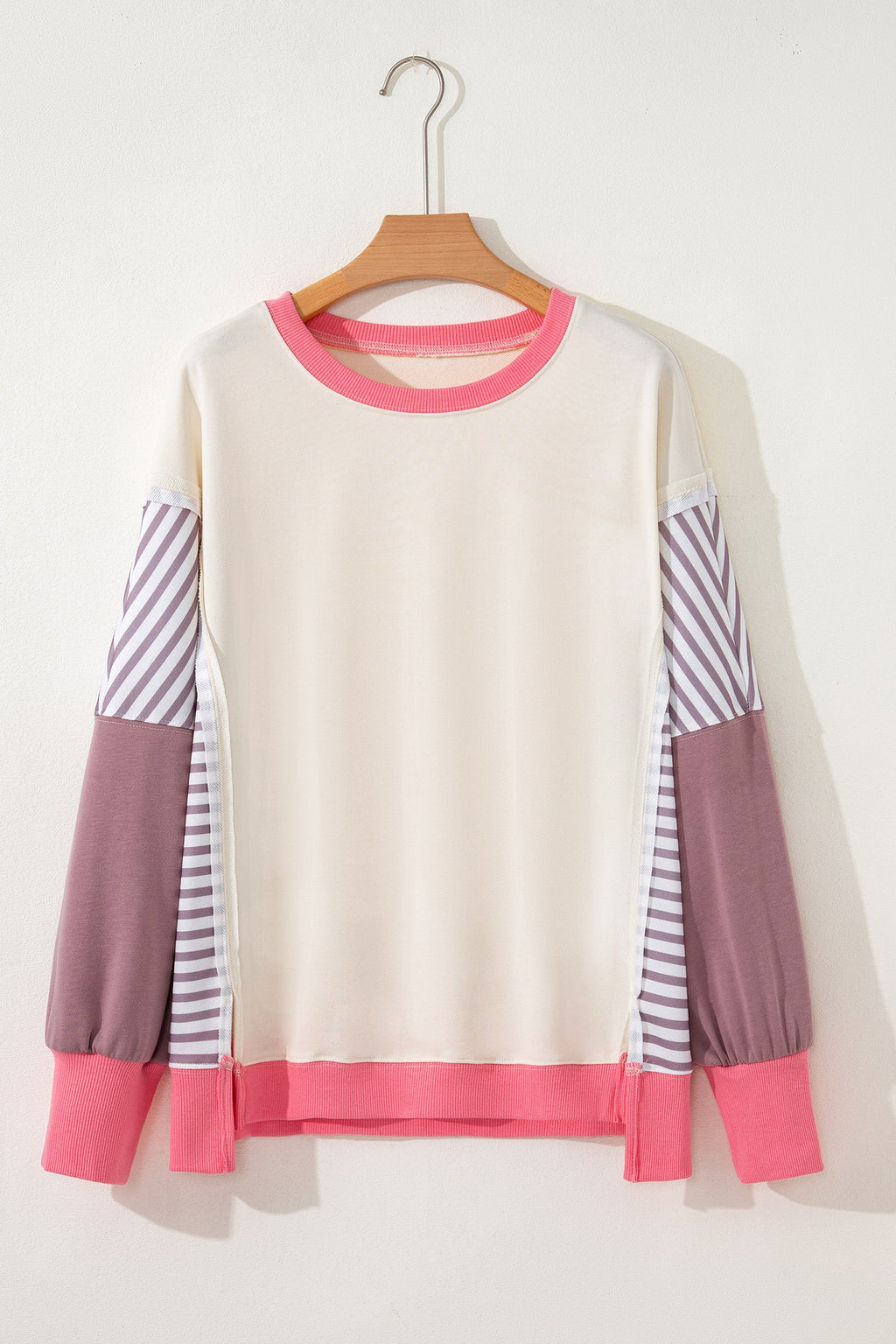 Cream sweatshirt with purple striped sleeves, mauve cuffs, and pink hem