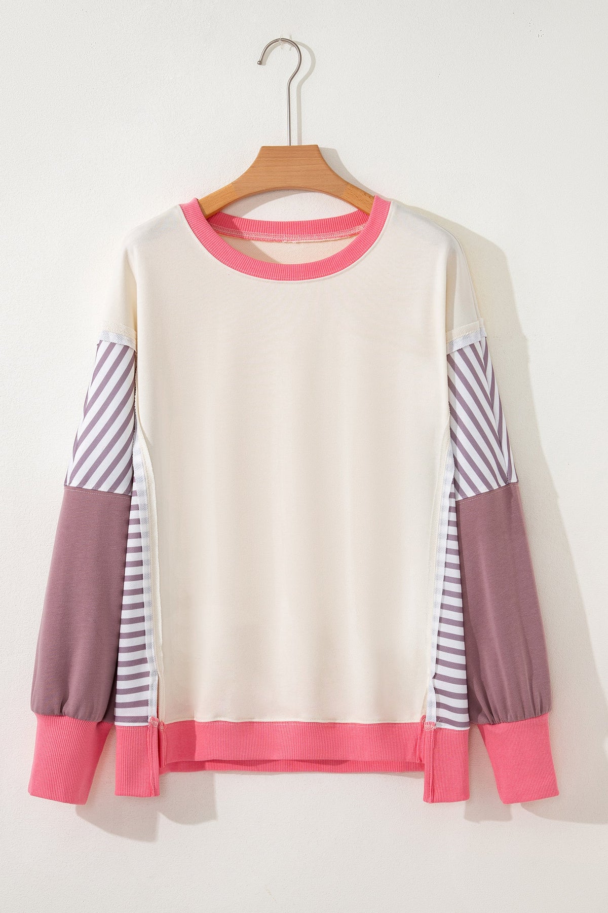 Cream sweatshirt with purple striped sleeves, mauve cuffs, and pink hem