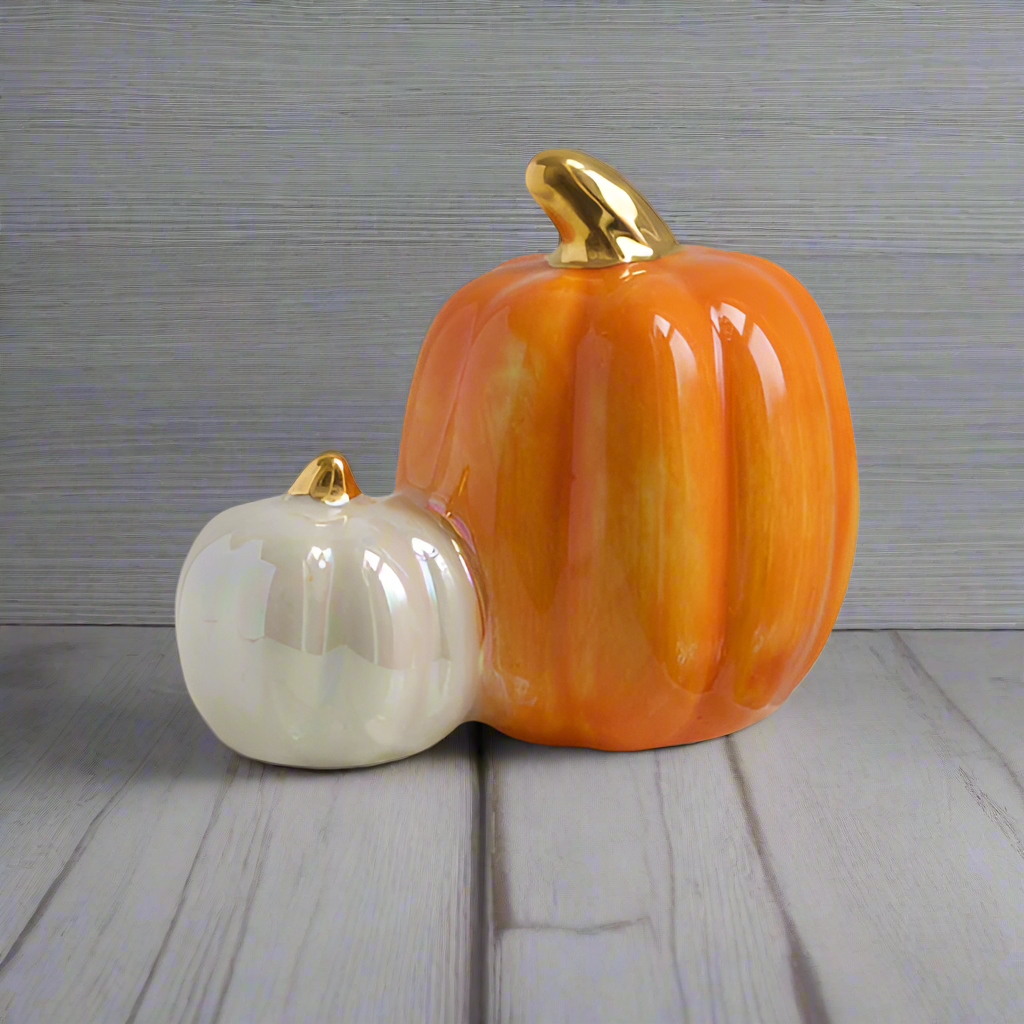 Nora Fleming mini pumpkin spice topper: orange pumpkin with gold stem beside white pumpkin