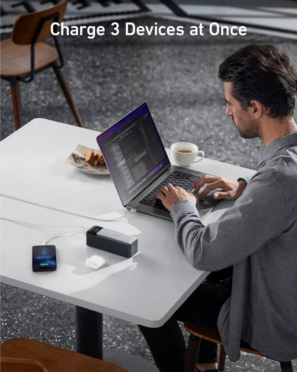 Black power bank with multiple ports charging three devices at once