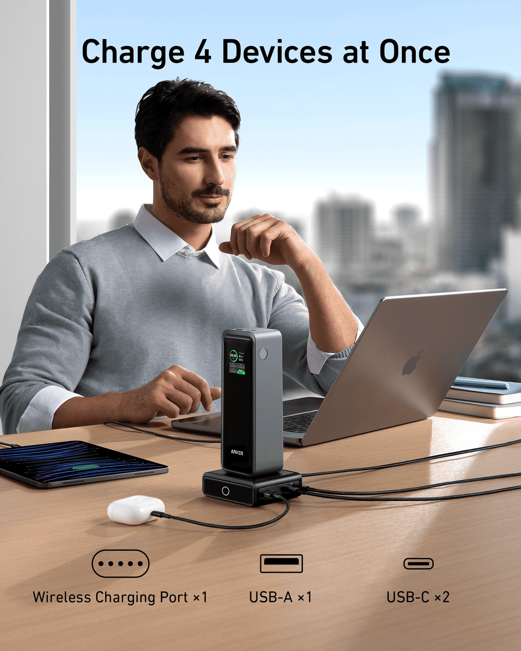Anker 100W charging base with power bank docked and multiple USB outputs