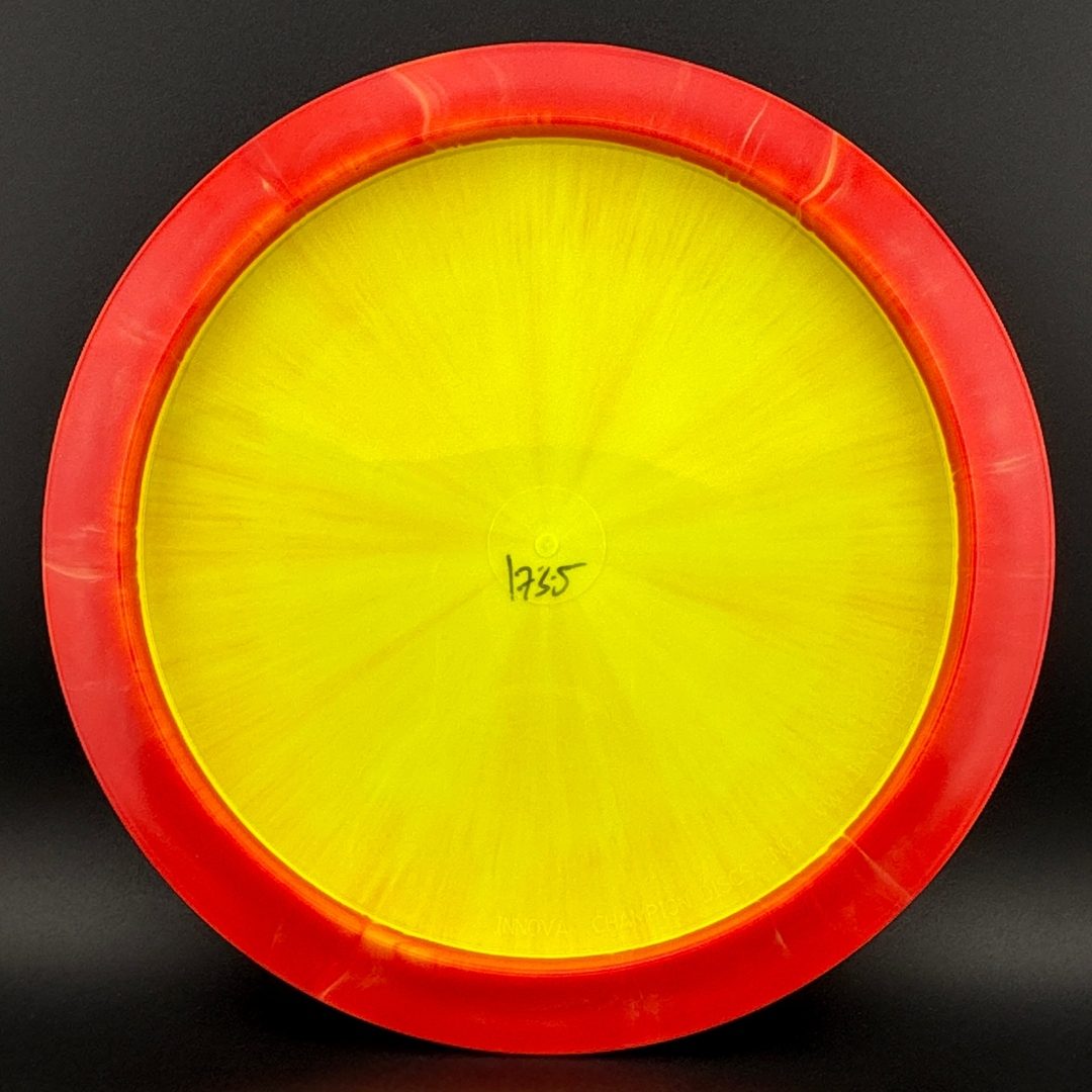 Disc golf driver underside with yellow interior and red rim