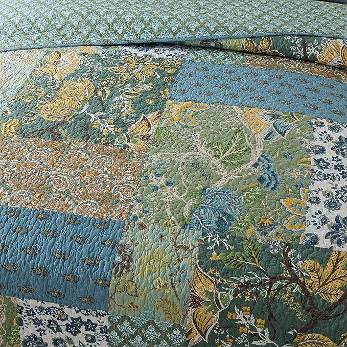 Quilted bedspread close-up with raised matelasse stitching and layered floral motifs