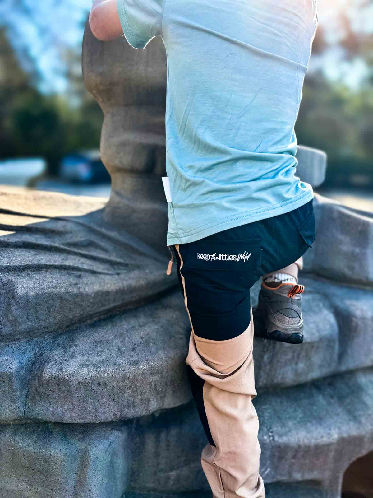 Dark navy and tan hiking pants with drawstring waist and elastic cuffs