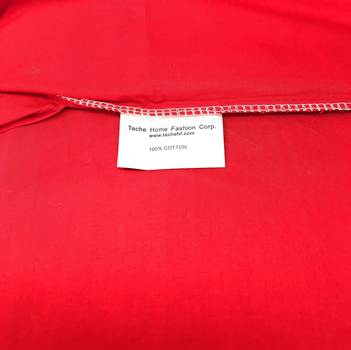 Red 100% cotton sheet corner with stitched edge and fabric label