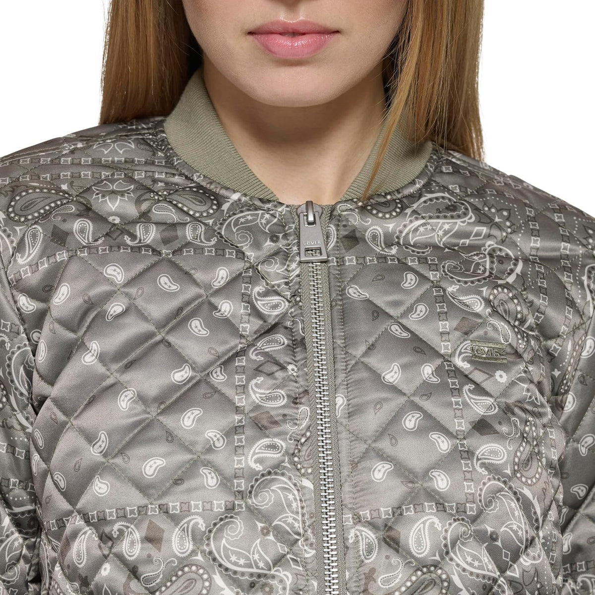Close-up of gray paisley quilt bomber jacket with zip front and diamond stitch pattern