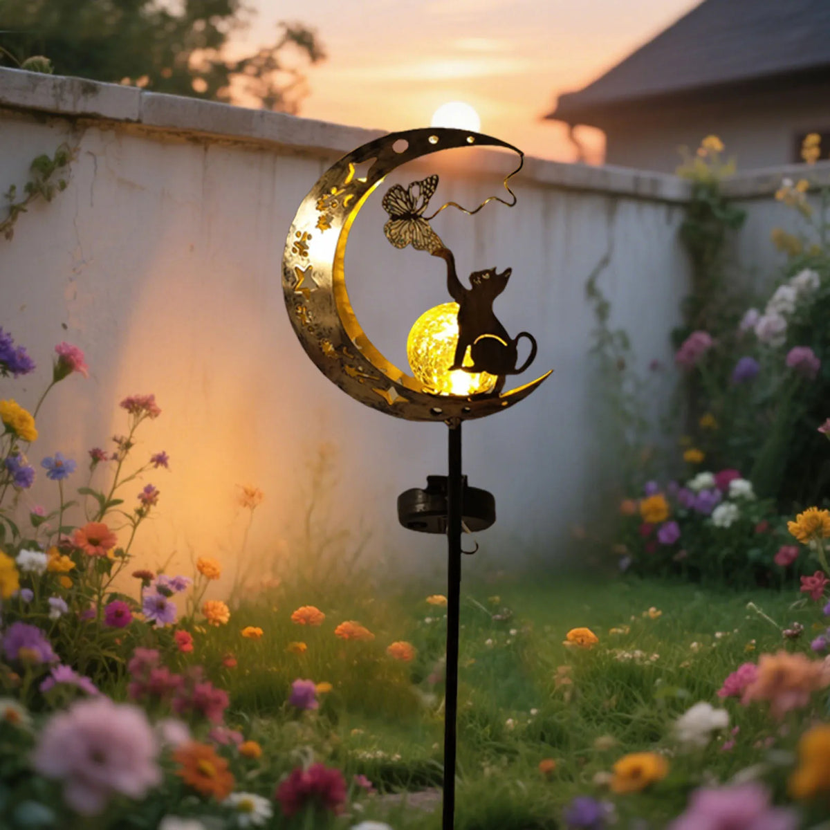 Solar moon-shaped garden lamp with cat silhouette and warm glowing bulb inside metal moon.