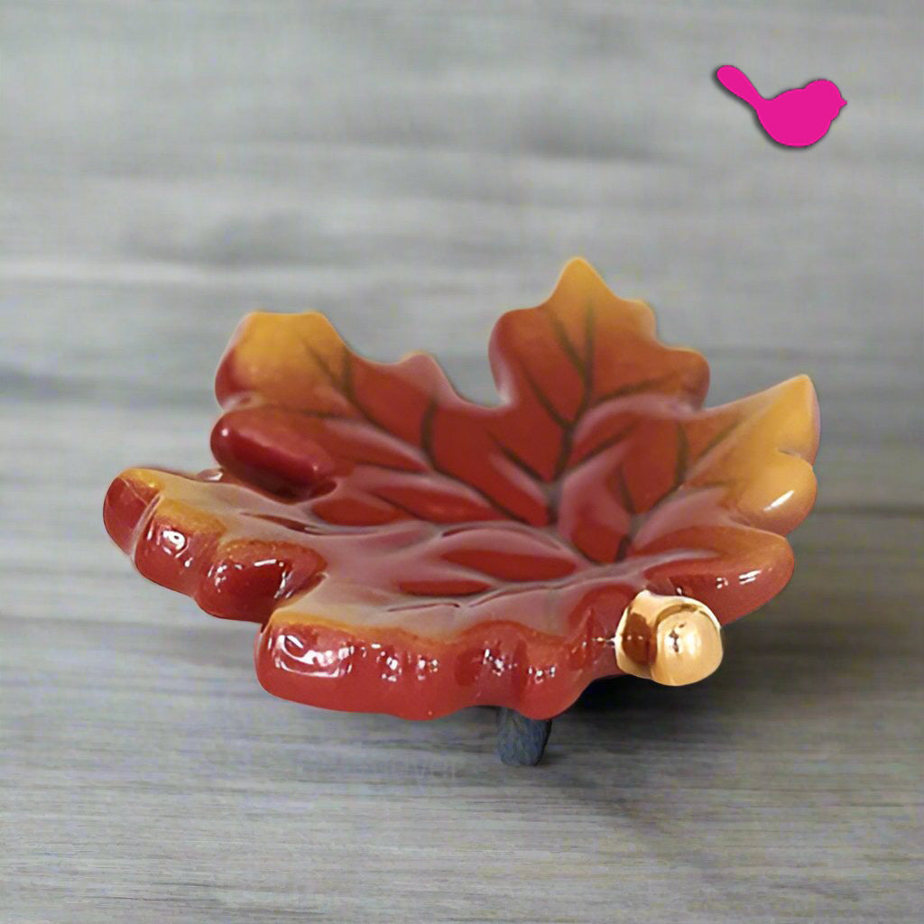 Glazed fall leaves mini ceramic piece in red, orange, and yellow with acorn
