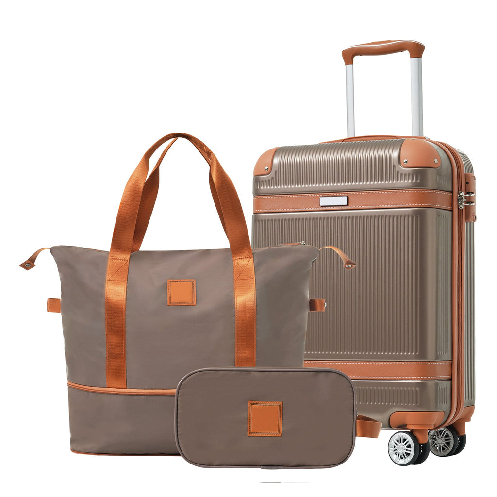 Gray carry-on suitcase with copper trim and matching duffle bag set
