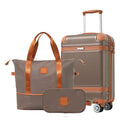 Gray carry-on suitcase with copper trim and matching duffle bag set