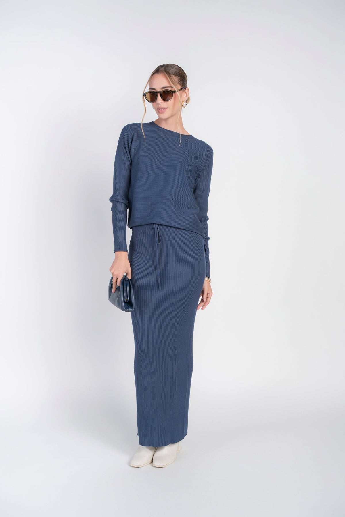 Long rib knit skirt in blue with tie-waist detail, straight pencil fit