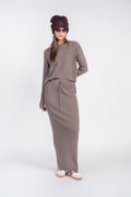 Mushroom ribbed knit sweater top with long sleeves and crew neck, tucked into skirt