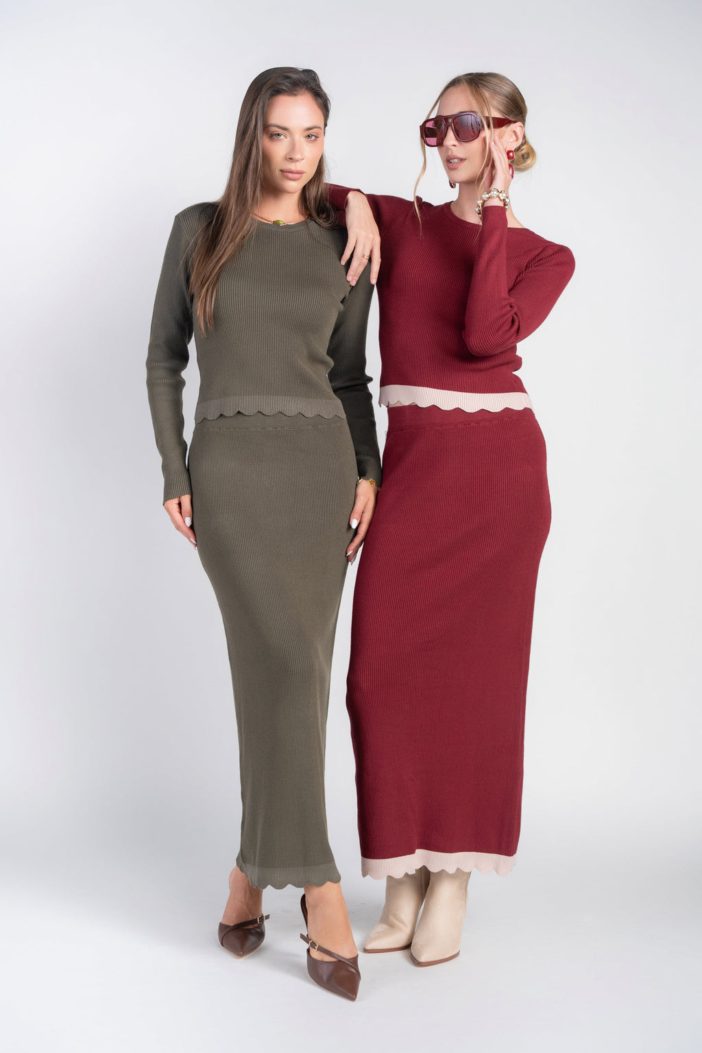 Olive scalloped hem knit midi skirt next to burgundy skirt