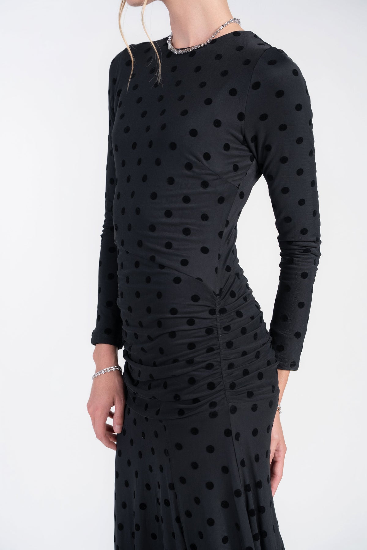 Black mesh dot maxi dress with ruched torso and long sleeves, upper body close-up