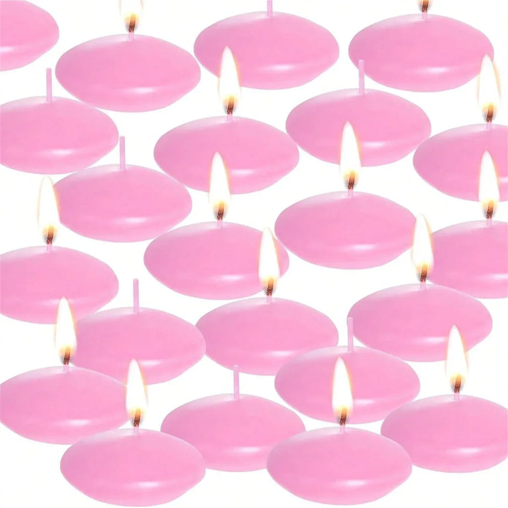 Pink floating candles with glowing wicks, round disc tops