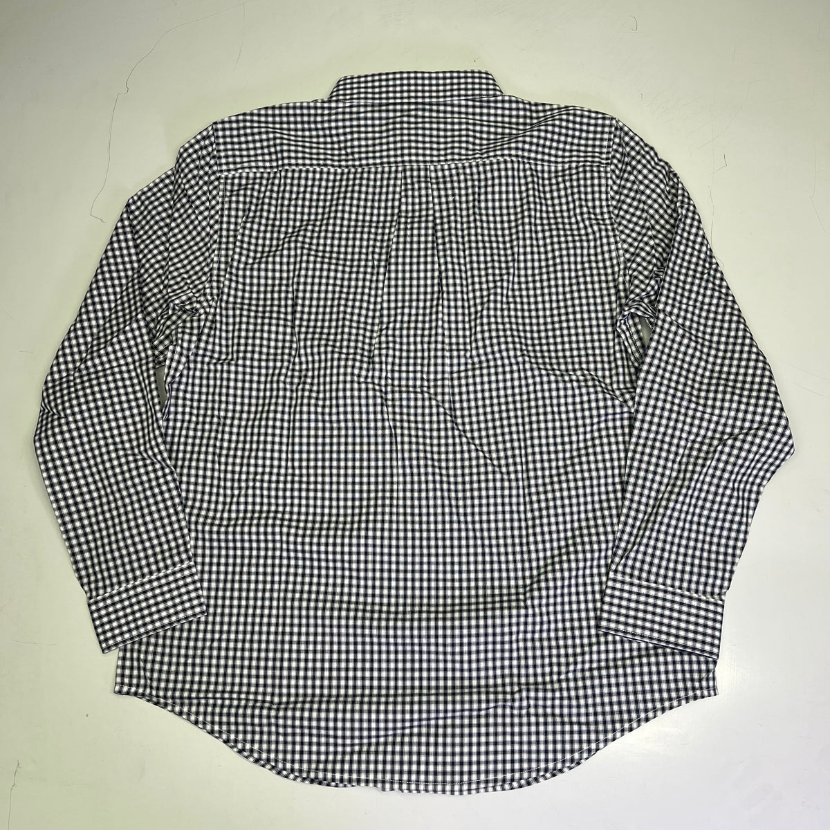 Men's button-up shirt, navy and white checkered, back view with collar