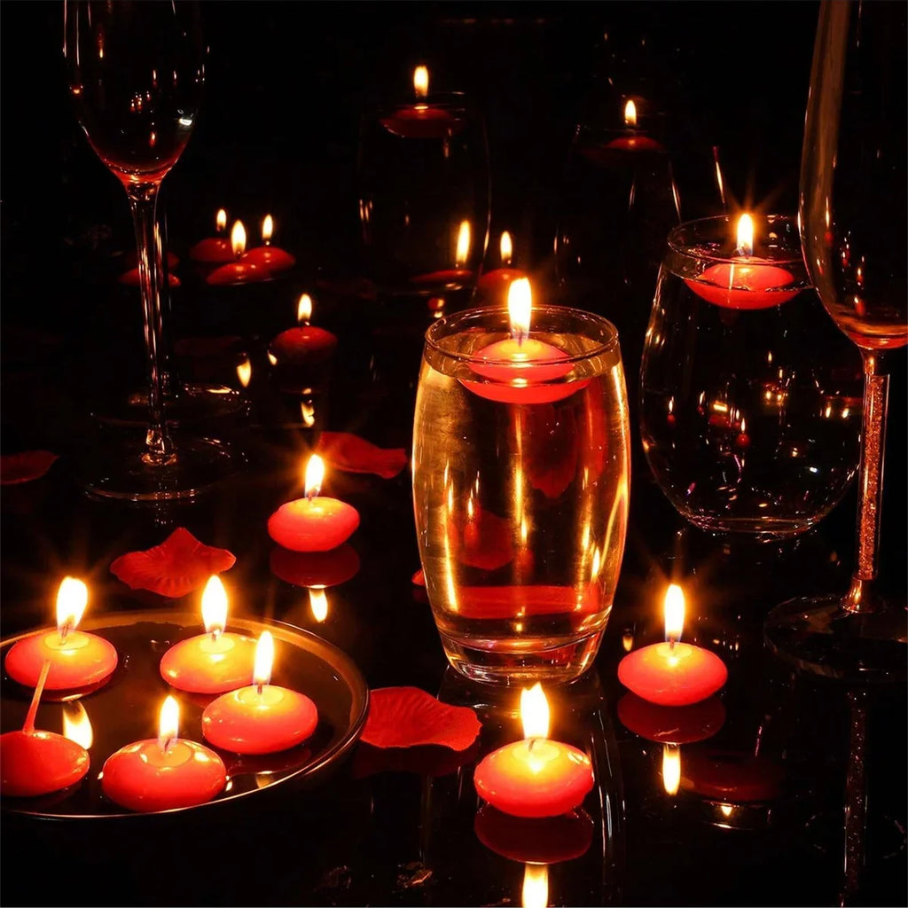 Red floating candles with flames around wine glasses and a drink centerpiece