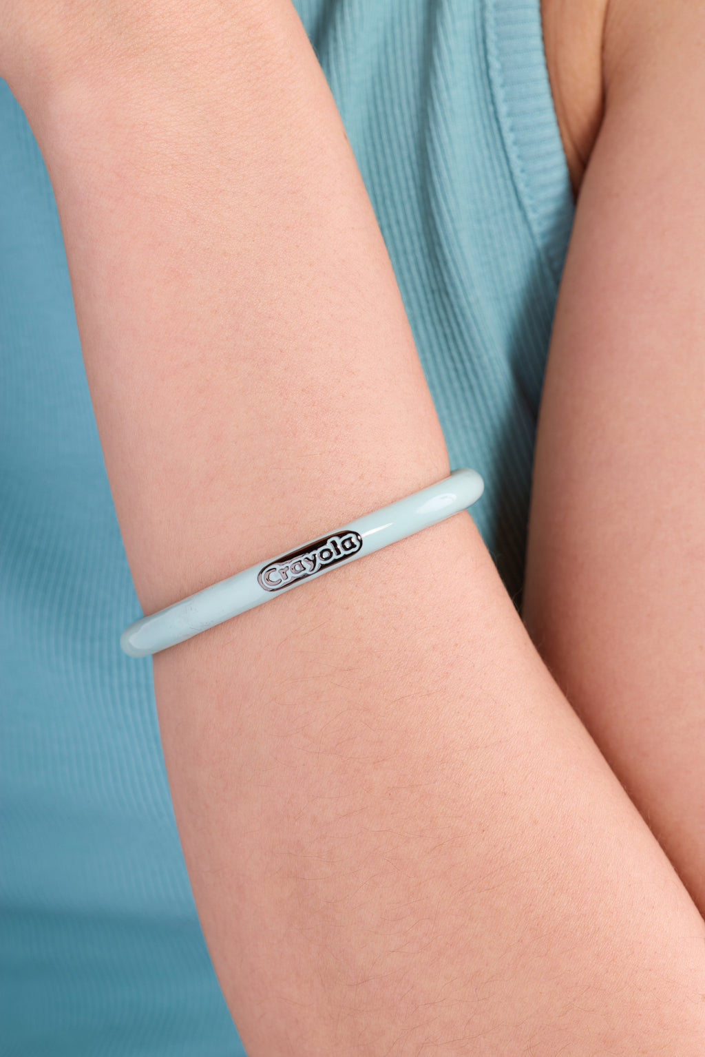 Robin's egg blue Crayola crayon cuff bracelet on wrist, with Crayola logo