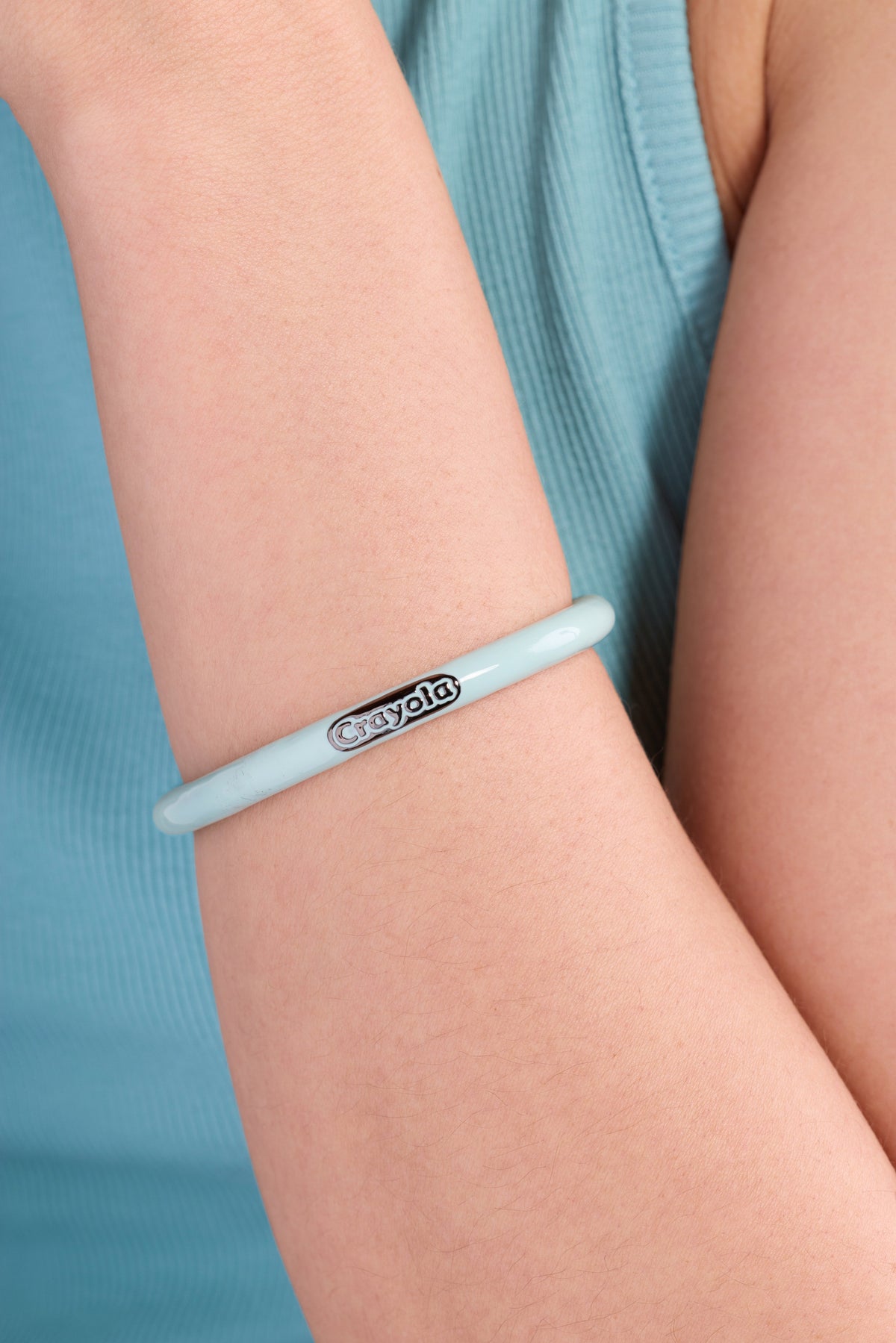 Robin's egg blue Crayola crayon cuff bracelet on wrist, with Crayola logo
