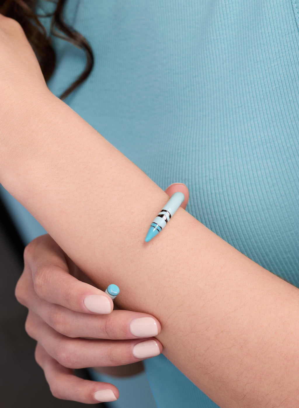 Robin's egg blue Crayola crayon cuff bracelet detail on wrist with striped end