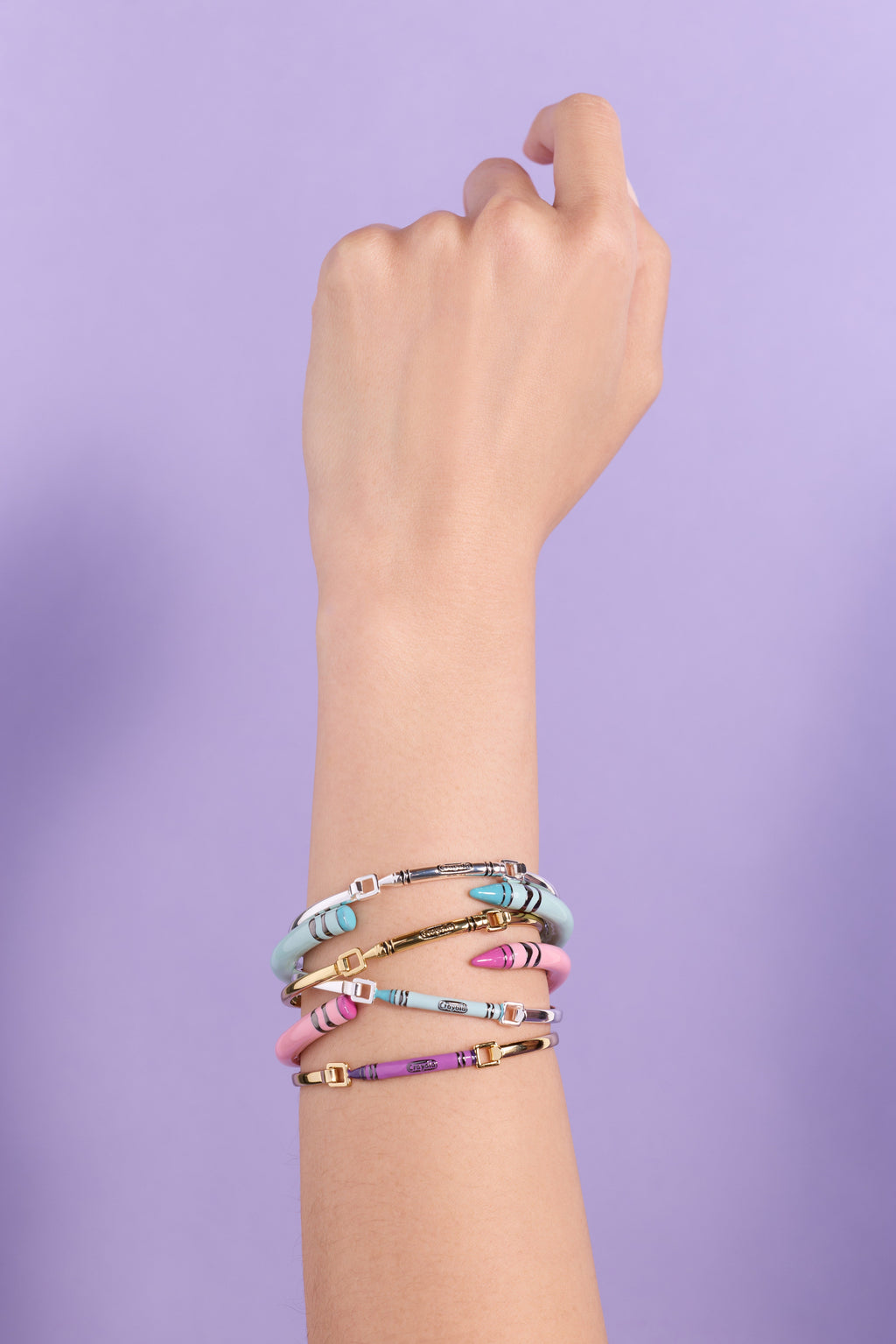 Robin's egg blue Crayola crayon cuff bracelet stacked with other bangles on wrist