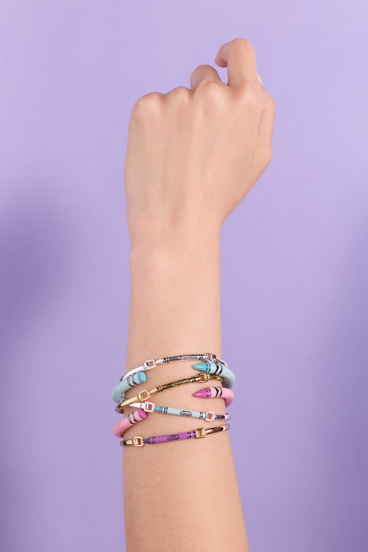Robin's egg blue Crayola crayon cuff bracelet stacked with other bangles on wrist