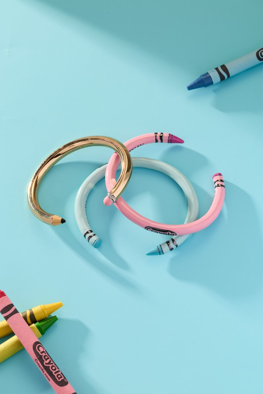 Crayon cuff bracelets in pink and light blue with gold clasps and striped ends