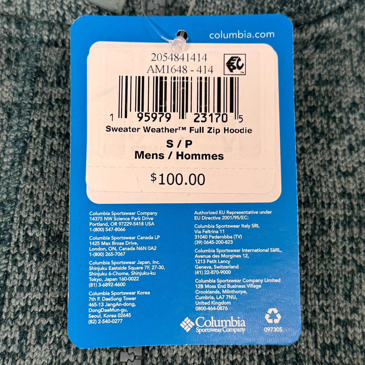 Teal heather fleece jacket retail tag with barcode, SKU, and $100 price