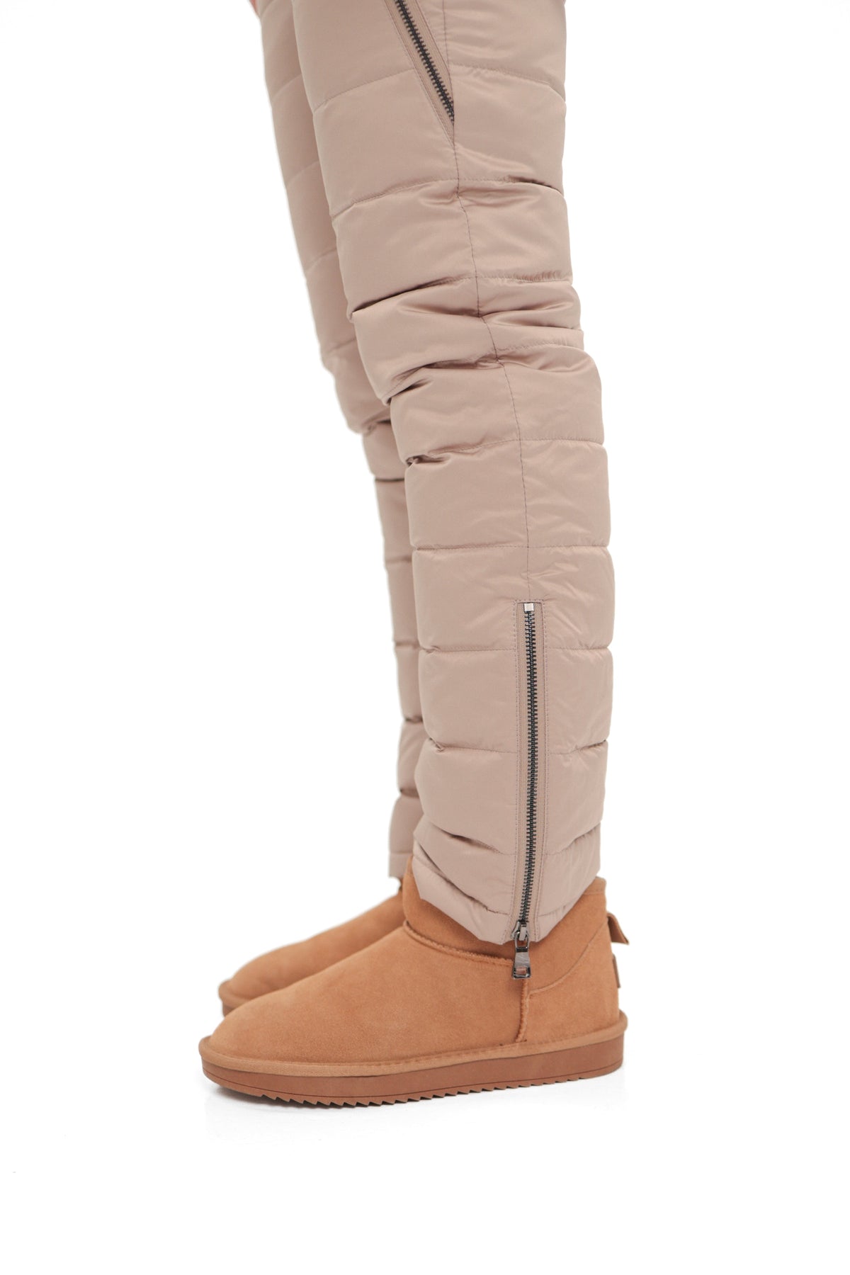 Beige snow pants with quilted pattern, zip ankle, and tan insulated boots
