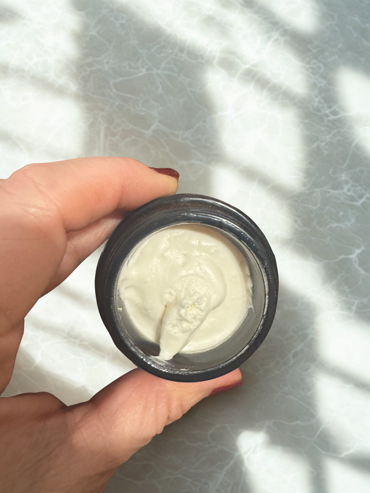 Whipped tallow body butter jar with white cream shown from above