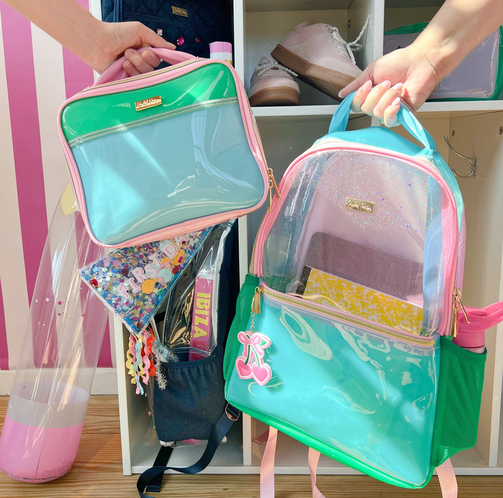 Clear aqua jelly backpack with pink piping and front pocket, viewed open