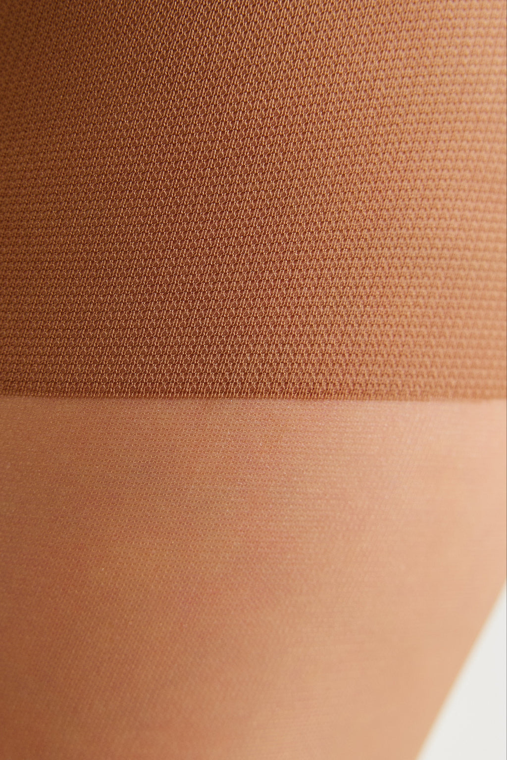 Tan tights knit texture close-up with waistband seam detail