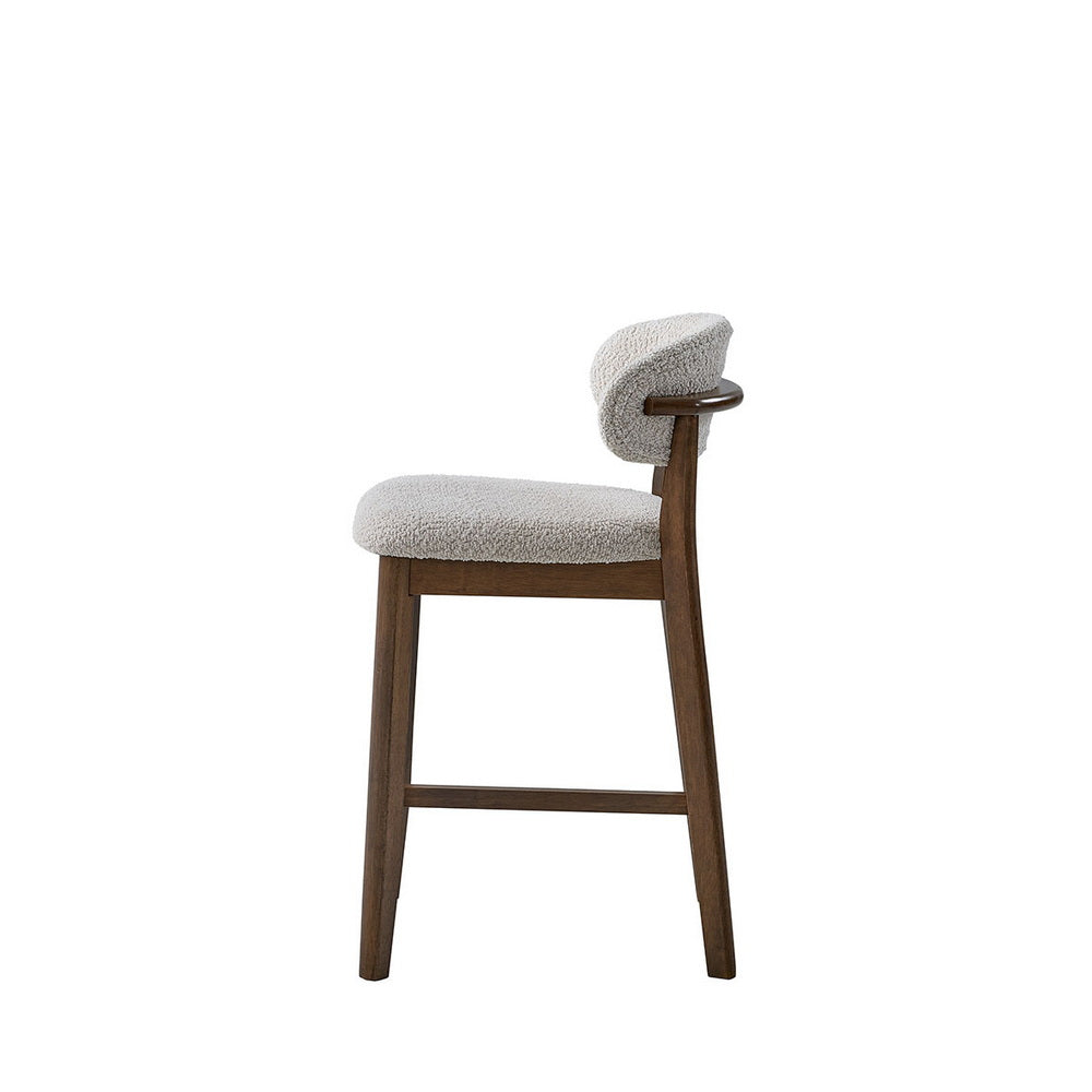 Light gray upholstered counter bar stool with rounded backrest and angled dark wood legs