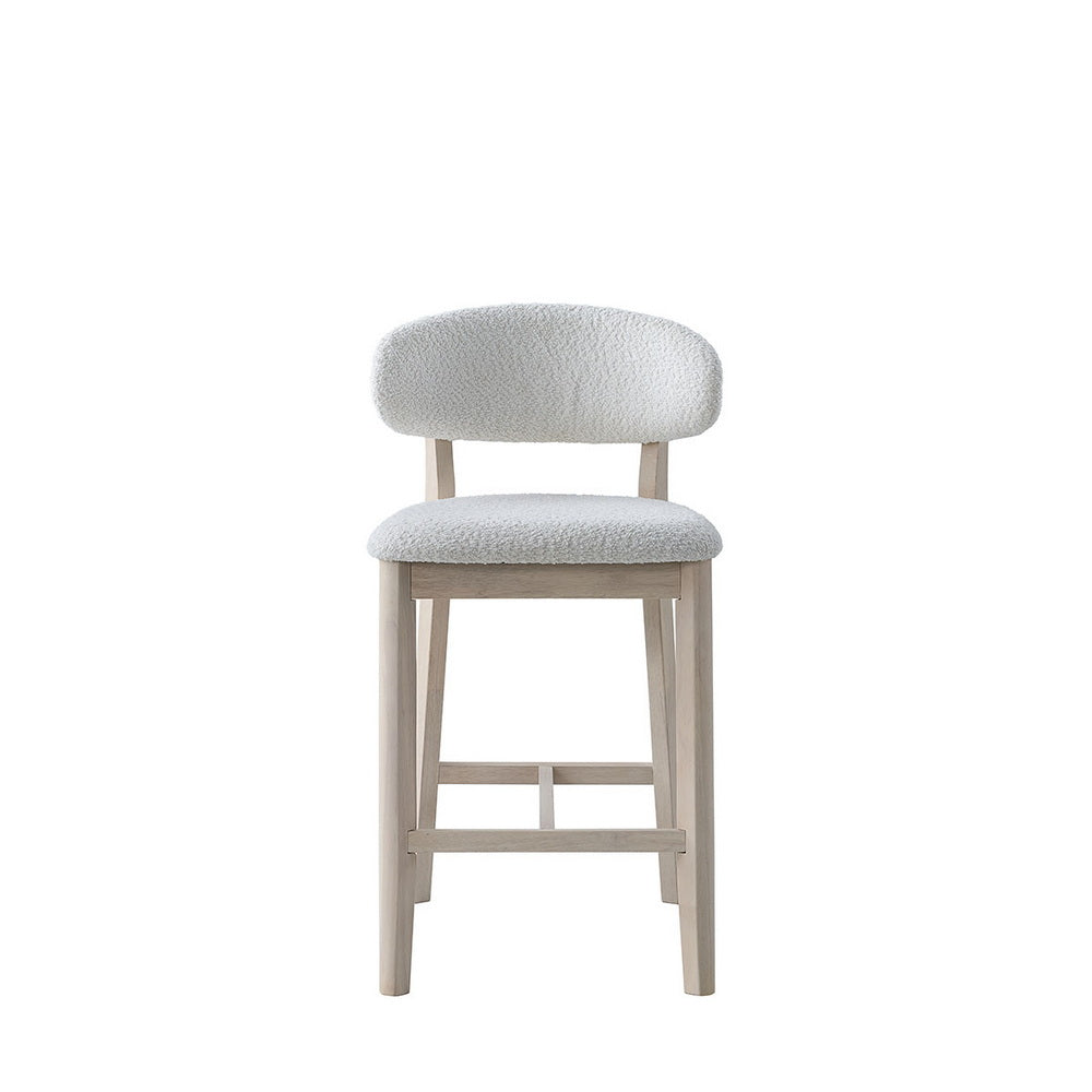 Cream upholstered bar stool with light wood legs and footrest