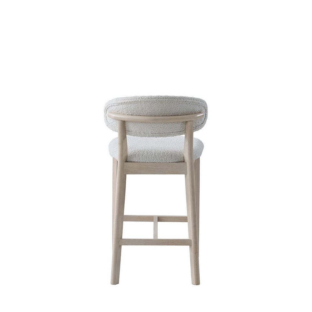 Cream upholstered bar stool with rounded top back and light wood frame
