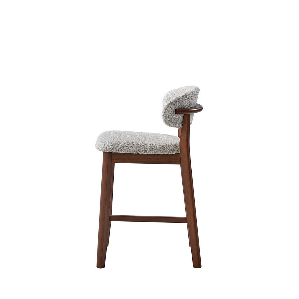 Upholstered bar stool with light gray boucle seat and curved back, dark wood legs