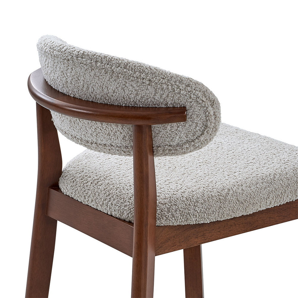 Upholstered bar stool seat and back in light gray boucle with dark wood frame