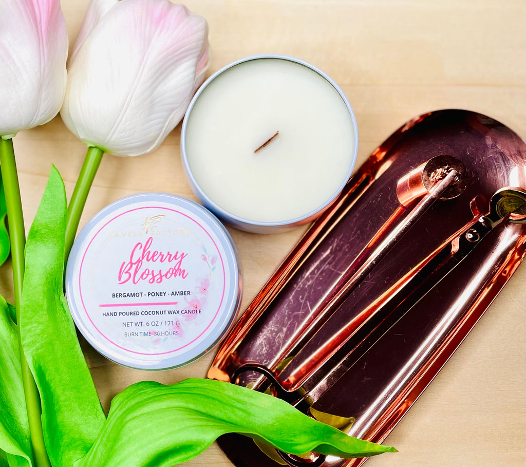 Cream wax wood wick candle labeled Cherry Blossom in round tin