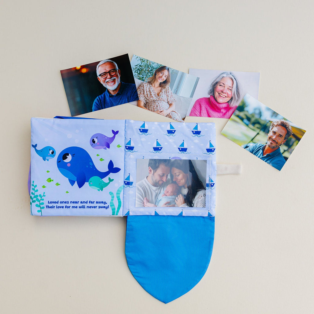 Blue cloth photo-pocket storybook album with whale illustrations and front pocket opening