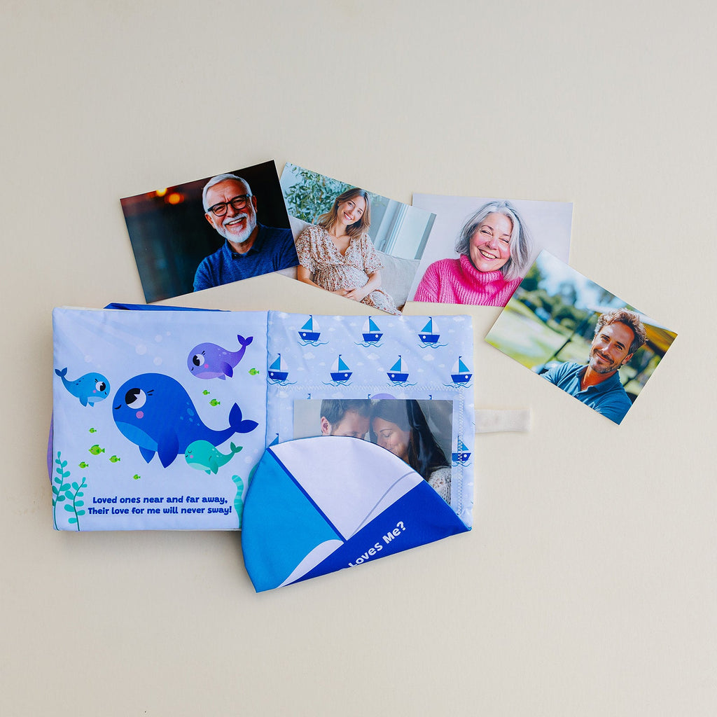 Blue photo-pocket storybook album laid flat with whale design and picture insert