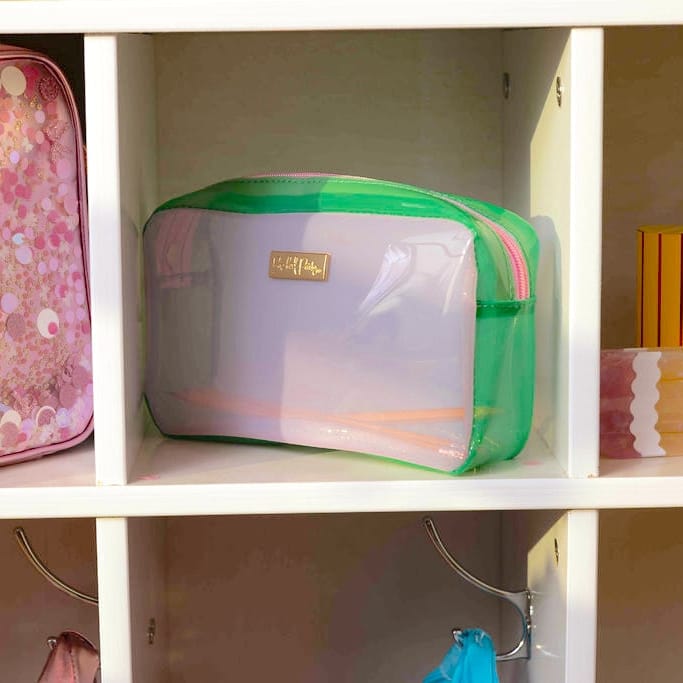 Colorblock jelly pouch inside drawer with clear front, green edges, and gold logo