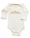 Cream long-sleeve bodysuit with orange pumpkin print and snap button closure