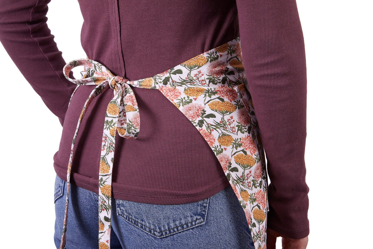 Floral half apron tied at waist with bow, multicolor floral print
