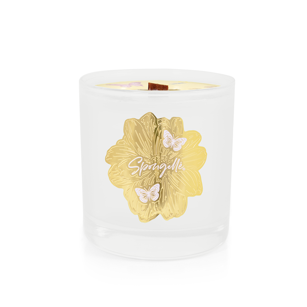White wax Botanica candle jar with gold floral logo and centered wick opening